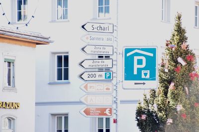 Close-up of road sign against built structure