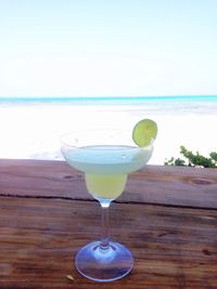 Close-up of cocktail on beach against clear sky