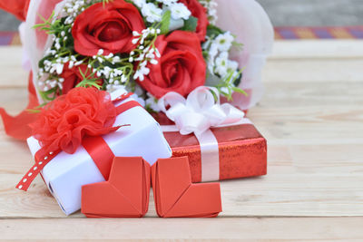 Close-up of red roses in box on table