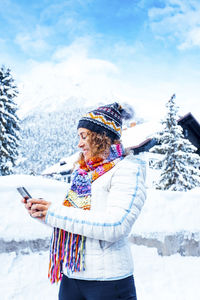 Young woman standing on snow