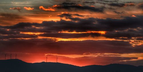 Wind turbines on mountain at sunset