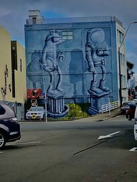 Car on street against buildings in city