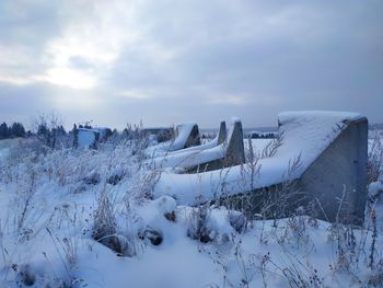 Snow covered field against sky