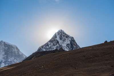 Scenic view of snowcapped mountains against clear sky