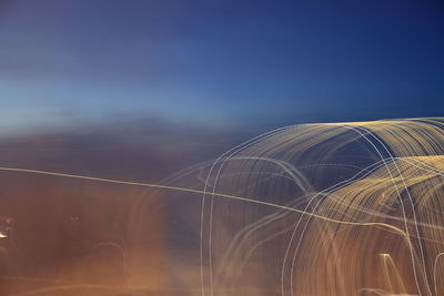 Low angle view of light painting against sky at dusk