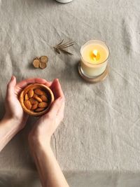 High angle view of hand holding tea cup on table