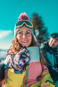 Portrait of smiling young woman photographing