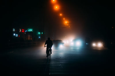 Fog in the night city after rain, car headlights