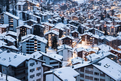 Snow covered houses in town during winter