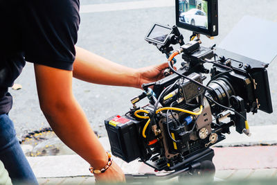 Cinema camera on film set, behind the scenes background, film crew production