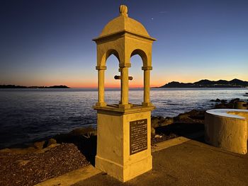 Scenic view of sea against clear sky during sunset