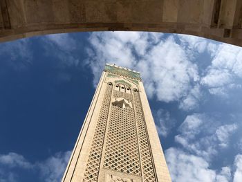 Low angle view of building against cloudy sky