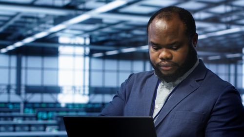 Young man using laptop at office