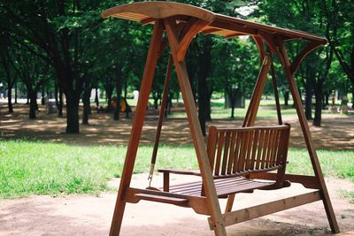 Empty chairs and table in park