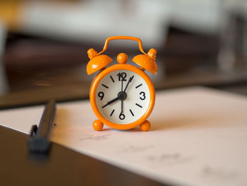 Close-up of clock on table