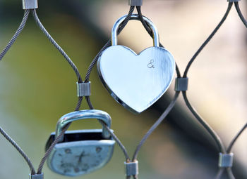 Close-up of love locks hanging on fence