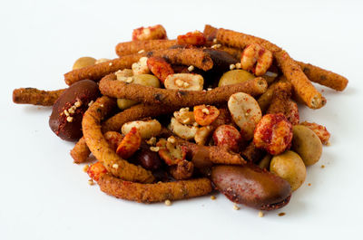 Close-up of bread in plate against white background