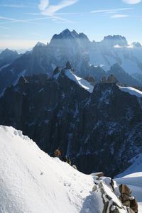 Scenic view of snow covered mountains against sky