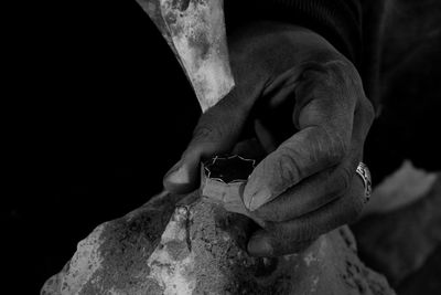 Midsection of man crafting in darkroom