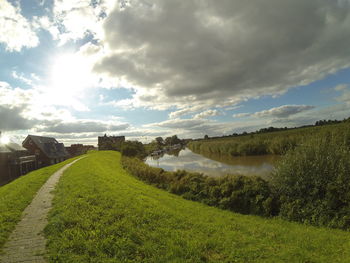 Scenic view of landscape against cloudy sky