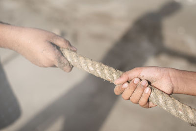 Close-up of hands holding rope