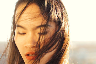 Close-up of woman outdoors in sunny day