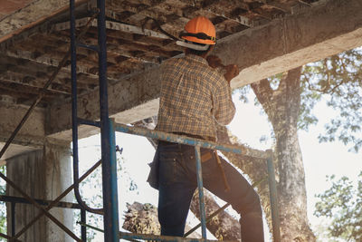 Rear view of manual worker at construction site