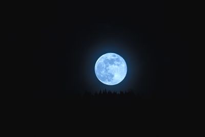 Low angle view of moon against sky at night