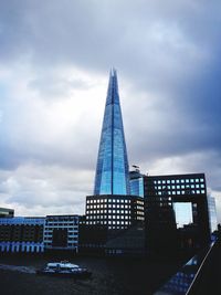 Low angle view of tower against cloudy sky