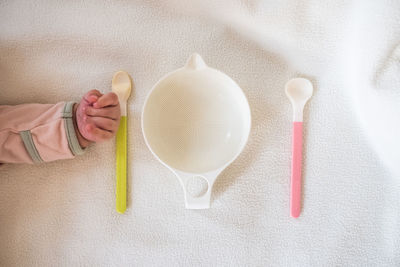 Directly above shot of hand holding ice cream on table