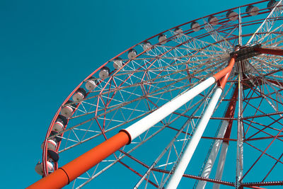 Low angle view of ferris wheel against blue sky