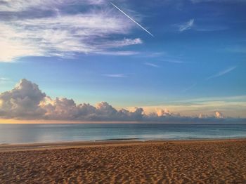 Scenic view of sea against cloudy sky