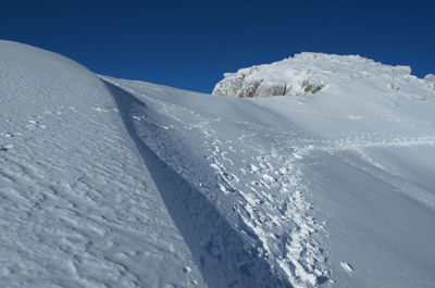 Snow covered mountain against clear sky