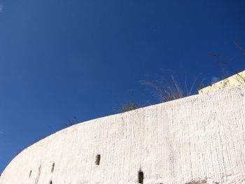 Low angle view of building against blue sky