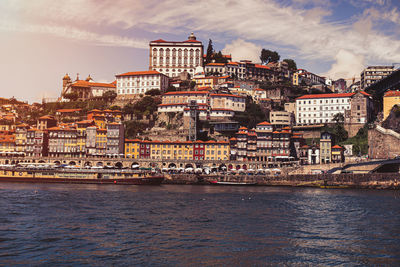 View of town by sea against sky