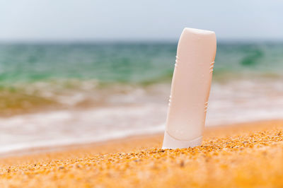 Cropped hand of person holding ice at beach