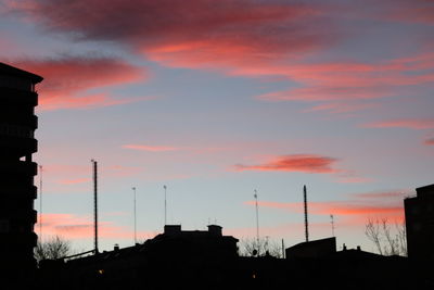 Low angle view of silhouette buildings against sky during sunset