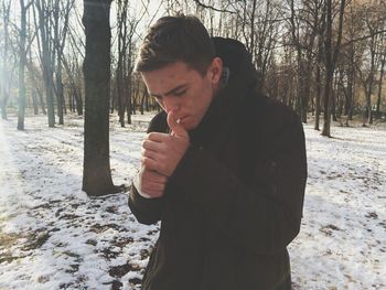 Full length of man on snow covered tree