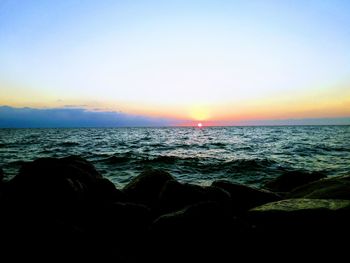 Scenic view of sea against clear sky during sunset