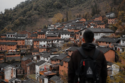 Rear view of man standing in town