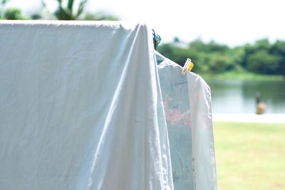 Clothes and flat sheet hanging on the clothesline with clothespin for drying from the heat of sun