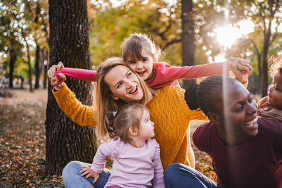 Side view of mother and daughter in park