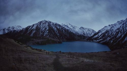 Scenic view of lake against cloudy sky