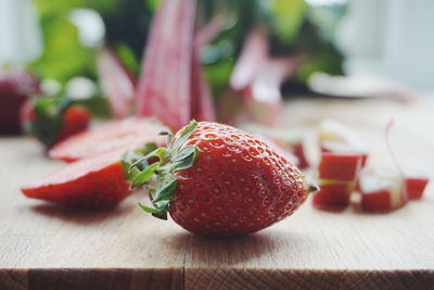 Surface level of chopped rhubarb and strawberries on cutting board