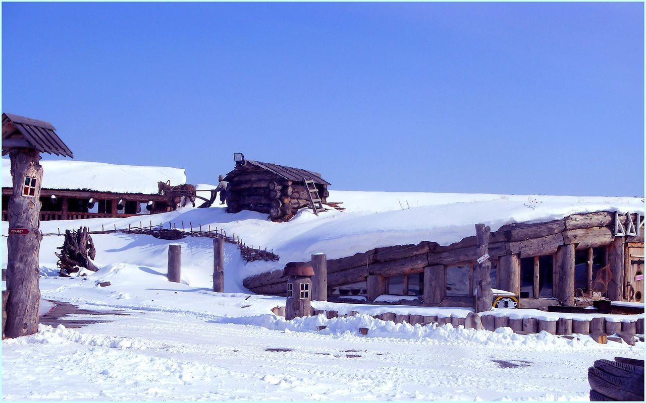 built structure, architecture, building exterior, clear sky, snow, winter, cold temperature, copy space, blue, house, beach, residential structure, season, sunlight, residential building, day, sea, nature, outdoors, sky