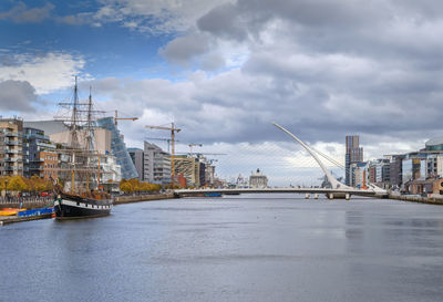 View of bridge over river against cloudy sky