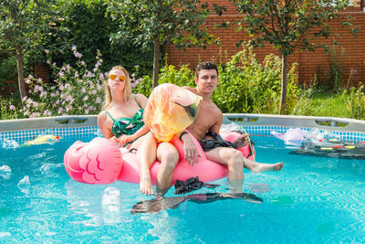 High angle view of men sitting in swimming pool