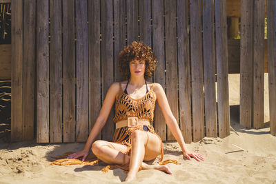 Portrait of young woman sitting at beach