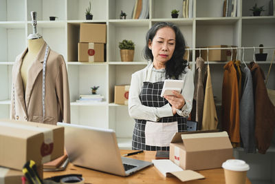 Portrait of smiling young woman reading book