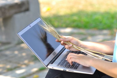 Low angle view of person using mobile phone